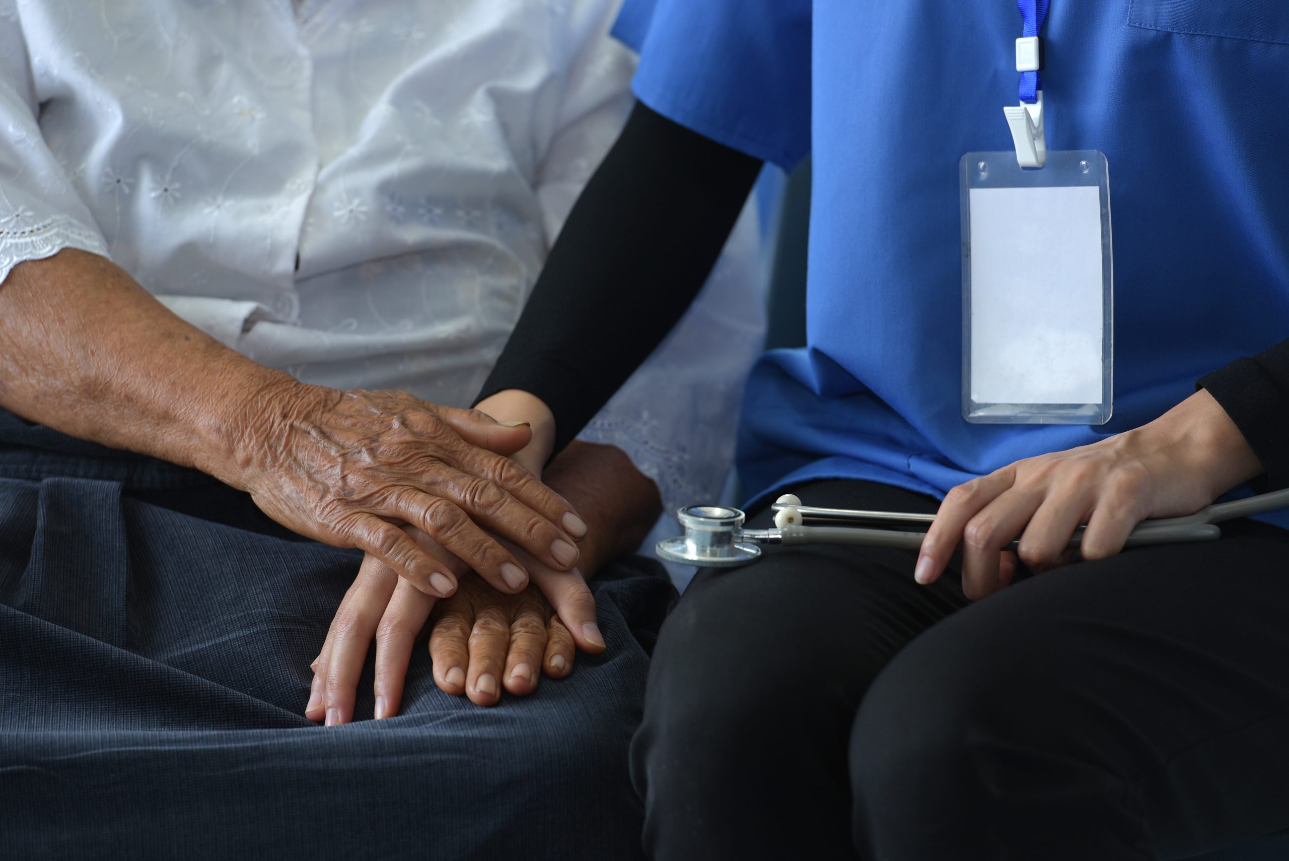 Elderly Hospice Elderly Care: Elderly Patients Get Visited by Asian Female Physicians. Shake hands and talk in the hospital